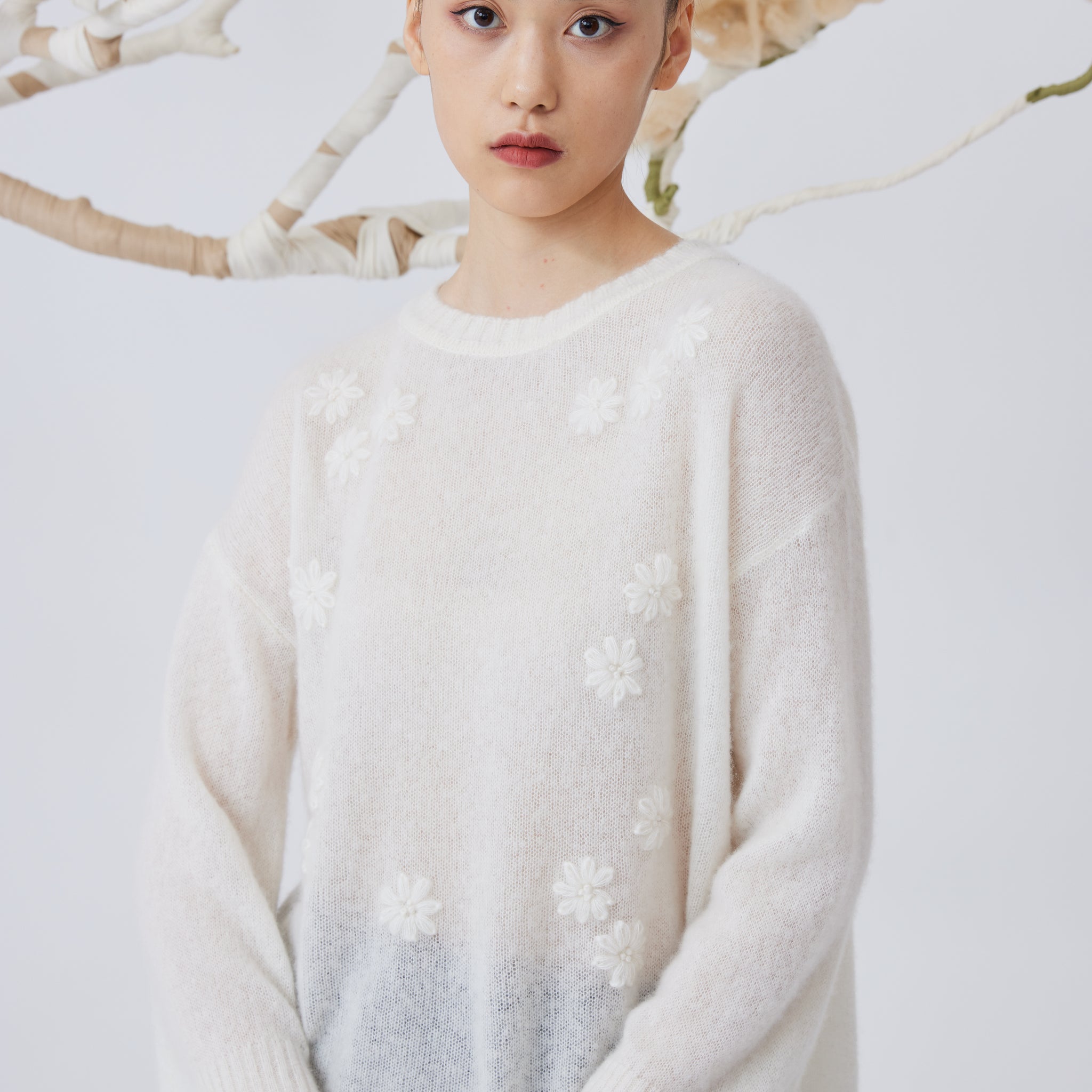 Women's flower embellished top